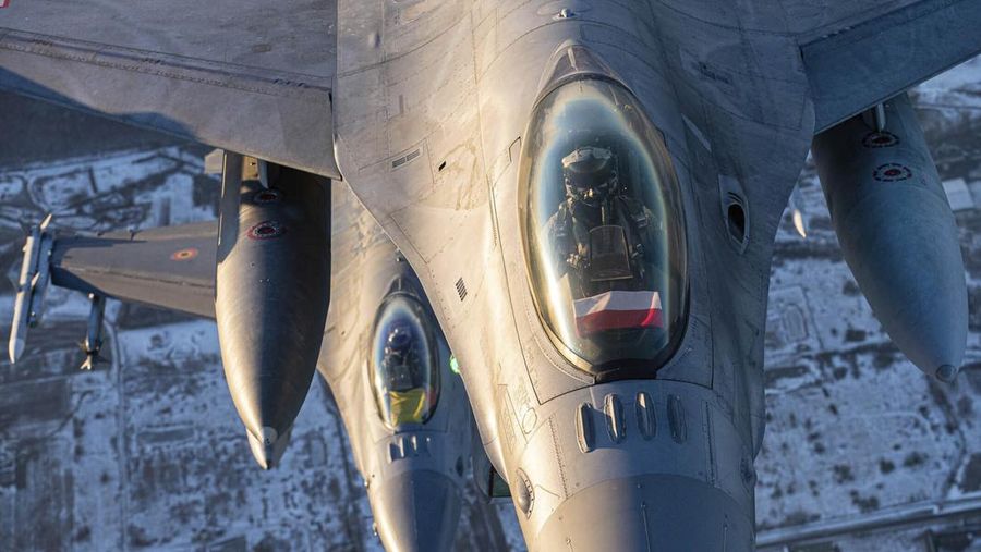 In this photo provided by Lithuanian Ministry of National Defense, Belgium Air Force F-16 fighter jet participating in NATO's Baltic Air Policing Mission, operates in Lithuanian airspace, Tuesday, Jan. 25, 2022. The NATO defence alliance on Monday said it was dispatching additional fighter jets and ships to Eastern Europe amid tensions with Russia. (Lithuanian Ministry of National Defense via AP)