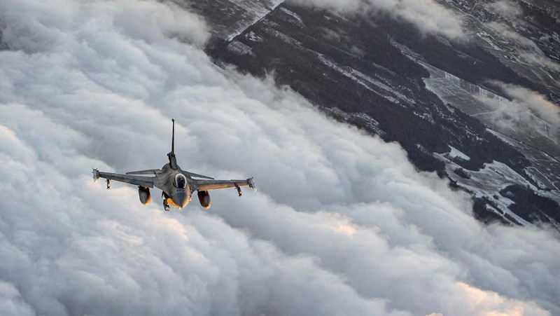 In this photo provided by Lithuanian Ministry of National Defense, Belgium Air Force F-16 fighter jet participating in NATO's Baltic Air Policing Mission, operates in Lithuanian airspace, Tuesday, Jan. 25, 2022. The NATO defence alliance on Monday said it was dispatching additional fighter jets and ships to Eastern Europe amid tensions with Russia. (Lithuanian Ministry of National Defense via AP)