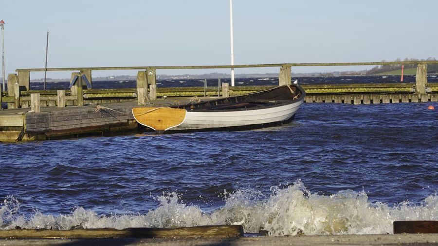 A man repairs a 10-meter wooden row boat, built in the Nordic clinker boat tradition, at the Viking Ship Museum's boatyard. Roskilde, Denmark, Monday, Jan. 17, 2022.  For thousands of years, wooden sail boats, best known for having been in use during the Viking-era, allowed the peoples of northern Europe to spread trade, influence and -- in some cases war — across the seas and rivers. In December, UNESCO, the U.N.’s culture agency, added the “clinker’ boat traditions to its list of “Intangible Cultural Heritage,” the result of the first joint nomination from the whole Nordic region. (AP Photo/James Brooks)