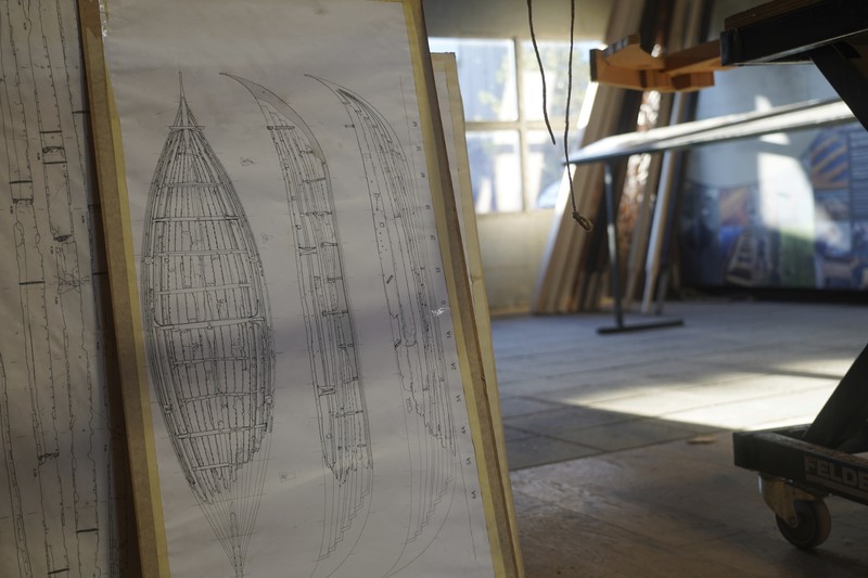 A man repairs a 10-meter wooden row boat, built in the Nordic clinker boat tradition, at the Viking Ship Museum's boatyard. Roskilde, Denmark, Monday, Jan. 17, 2022.  For thousands of years, wooden sail boats, best known for having been in use during the Viking-era, allowed the peoples of northern Europe to spread trade, influence and -- in some cases war — across the seas and rivers. In December, UNESCO, the U.N.’s culture agency, added the “clinker’ boat traditions to its list of “Intangible Cultural Heritage,” the result of the first joint nomination from the whole Nordic region. (AP Photo/James Brooks)