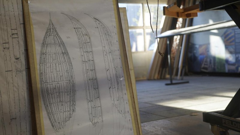 A man repairs a 10-meter wooden row boat, built in the Nordic clinker boat tradition, at the Viking Ship Museum's boatyard. Roskilde, Denmark, Monday, Jan. 17, 2022.  For thousands of years, wooden sail boats, best known for having been in use during the Viking-era, allowed the peoples of northern Europe to spread trade, influence and -- in some cases war — across the seas and rivers. In December, UNESCO, the U.N.’s culture agency, added the “clinker’ boat traditions to its list of “Intangible Cultural Heritage,” the result of the first joint nomination from the whole Nordic region. (AP Photo/James Brooks)
