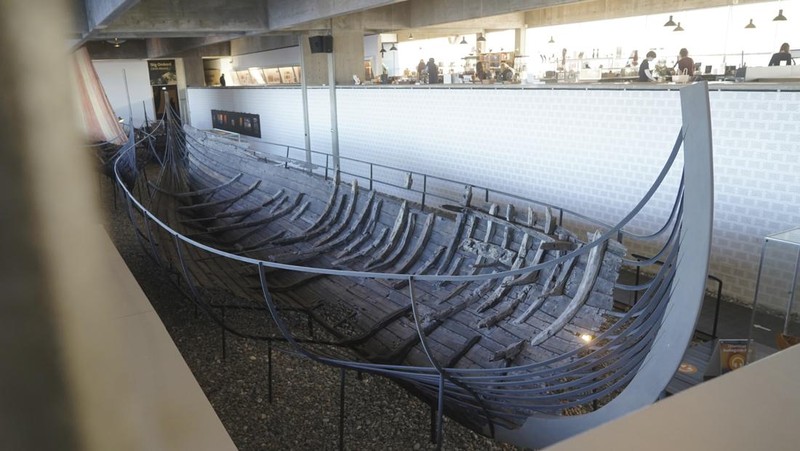 A man repairs a 10-meter wooden row boat, built in the Nordic clinker boat tradition, at the Viking Ship Museum's boatyard. Roskilde, Denmark, Monday, Jan. 17, 2022.  For thousands of years, wooden sail boats, best known for having been in use during the Viking-era, allowed the peoples of northern Europe to spread trade, influence and -- in some cases war — across the seas and rivers. In December, UNESCO, the U.N.’s culture agency, added the “clinker’ boat traditions to its list of “Intangible Cultural Heritage,” the result of the first joint nomination from the whole Nordic region. (AP Photo/James Brooks)