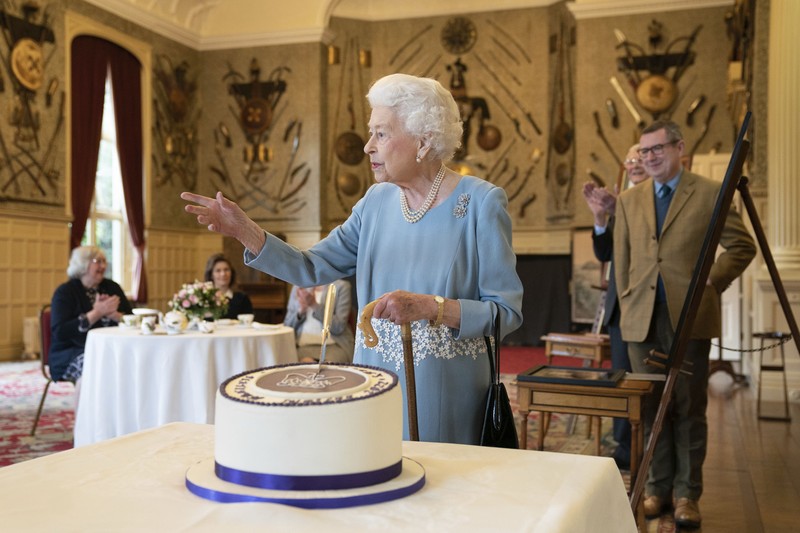 Britain's Queen Elizabeth II looks at a display of memorabilia from her Golden and Platinum Jubilees in the Oak Room at Windsor Castle, Windsor, England, in this undated but recent image that was released on Friday Feb. 4, 2022. Queen Elizabeth II will mark 70 years on the throne Sunday Feb. 6, an unprecedented reign that has made her a symbol of stability as the United Kingdom navigated an age of uncertainty. (Steve Parsons/Pool via AP)
