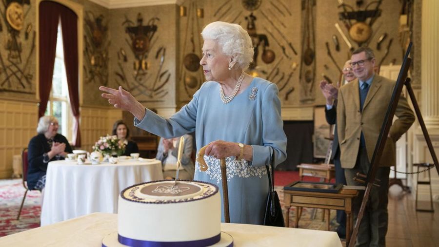 Britain's Queen Elizabeth II looks at a display of memorabilia from her Golden and Platinum Jubilees in the Oak Room at Windsor Castle, Windsor, England, in this undated but recent image that was released on Friday Feb. 4, 2022. Queen Elizabeth II will mark 70 years on the throne Sunday Feb. 6, an unprecedented reign that has made her a symbol of stability as the United Kingdom navigated an age of uncertainty. (Steve Parsons/Pool via AP)