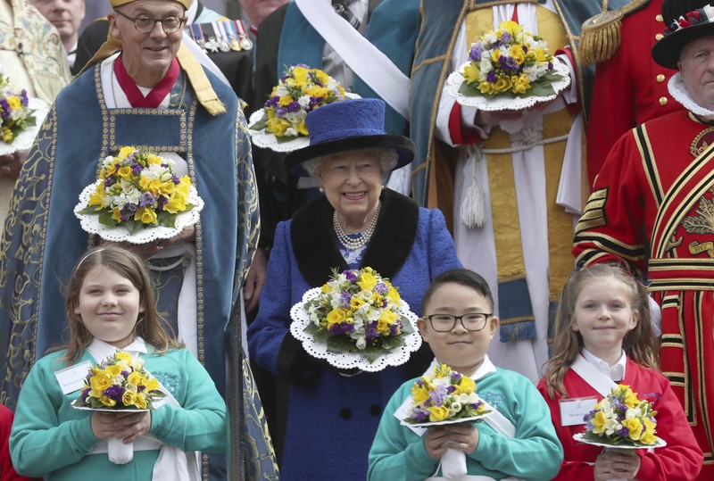 Britain's Queen Elizabeth II looks at a display of memorabilia from her Golden and Platinum Jubilees in the Oak Room at Windsor Castle, Windsor, England, in this undated but recent image that was released on Friday Feb. 4, 2022. Queen Elizabeth II will mark 70 years on the throne Sunday Feb. 6, an unprecedented reign that has made her a symbol of stability as the United Kingdom navigated an age of uncertainty. (Steve Parsons/Pool via AP)