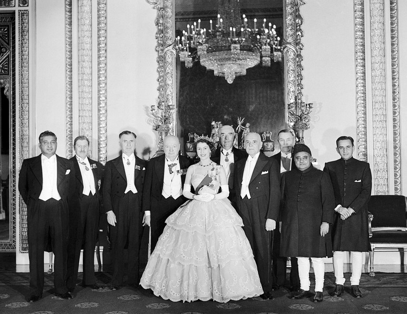 CORRECTION Britain Queen Platinum Jubilee Britain's Queen Elizabeth II looks at a display of memorabilia from her Golden and Platinum Jubilees in the Oak Room at Windsor Castle, Windsor, England, in this undated but recent image that was released on Friday Feb. 4, 2022. Queen Elizabeth II will mark 70 years on the throne Sunday Feb. 6, an unprecedented reign that has made her a symbol of stability as the United Kingdom navigated an age of uncertainty. (Steve Parsons/Pool via AP)