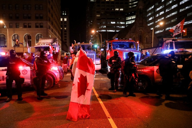 Demonstrators have a dance party in the street outside the Rideau Centre as truckers and supporters continue to protest coronavirus disease (COVID-19) vaccine mandates, in Ottawa, Ontario, Canada, February 5, 2022. REUTERS/Blair Gable