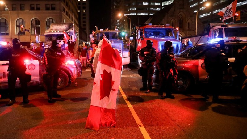 Demonstrators have a dance party in the street outside the Rideau Centre as truckers and supporters continue to protest coronavirus disease (COVID-19) vaccine mandates, in Ottawa, Ontario, Canada, February 5, 2022. REUTERS/Blair Gable