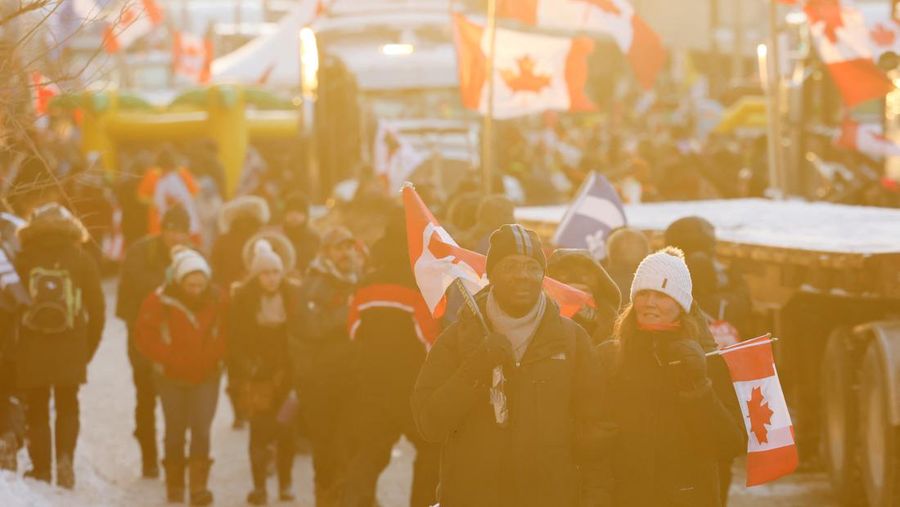 Demonstrators have a dance party in the street outside the Rideau Centre as truckers and supporters continue to protest coronavirus disease (COVID-19) vaccine mandates, in Ottawa, Ontario, Canada, February 5, 2022. REUTERS/Blair Gable