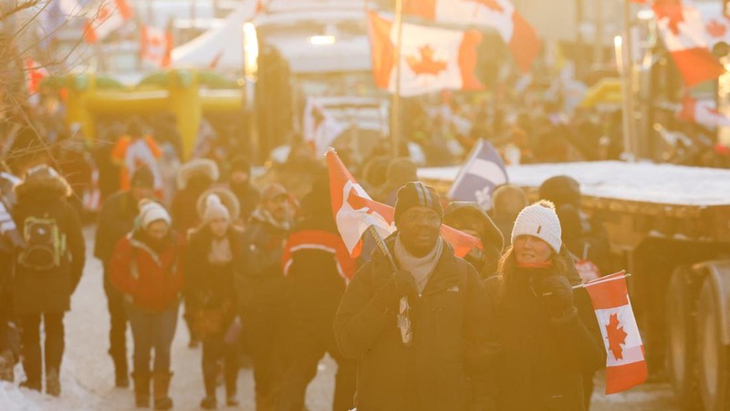 Demonstrators have a dance party in the street outside the Rideau Centre as truckers and supporters continue to protest coronavirus disease (COVID-19) vaccine mandates, in Ottawa, Ontario, Canada, February 5, 2022. REUTERS/Blair Gable
