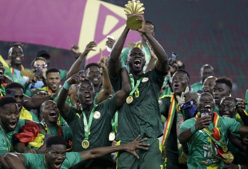 APTOPIX Cameroon African Cup Soccer Senegal's players celebrate with trophy after winning the African Cup of Nations 2022 final soccer match between Senegal and Egypt at the Ahmadou Ahidjo stadium in Yaounde, Cameroon, Sunday, Feb. 6, 2022. (AP Photo/Sunday Alamba)