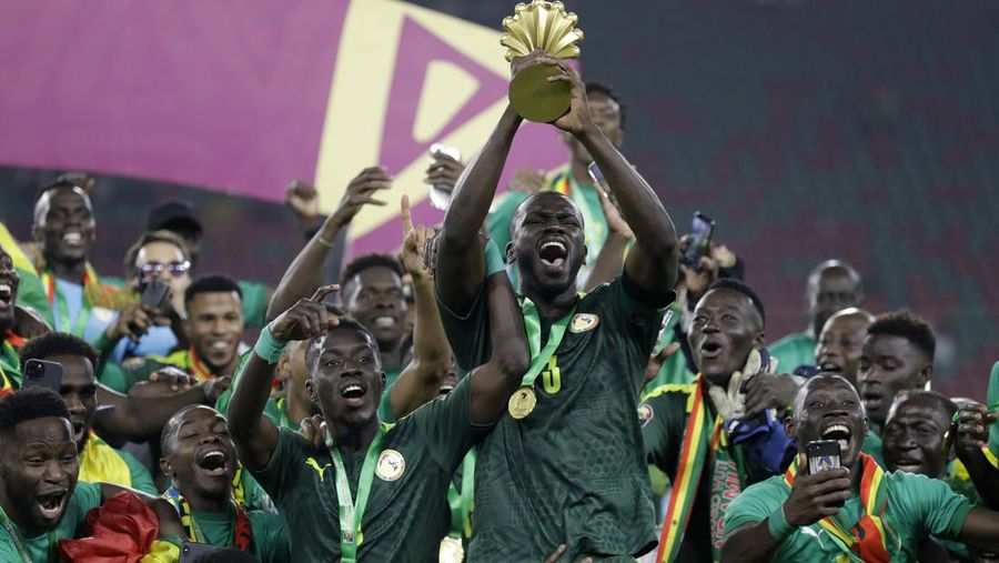 Senegal's players celebrate with trophy after winning the African Cup of Nations 2022 final soccer match between Senegal and Egypt at the Ahmadou Ahidjo stadium in Yaounde, Cameroon, Sunday, Feb. 6, 2022. (AP Photo/Sunday Alamba)