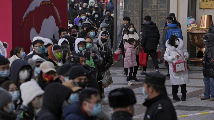 A man holds the Olympic mascot Bing Dwen Dwen doll which he purchased form a store selling 2022 Winter Olympics memorabilia in Beijing, Monday, Feb. 7, 2022. The race is on to snap up scarce 2022 Winter Olympics souvenirs. Dolls of mascot Bing Dwen Dwen, a panda in a winter coat, sold out after buyers waited in line overnight in freezing weather. (AP Photo/Andy Wong)