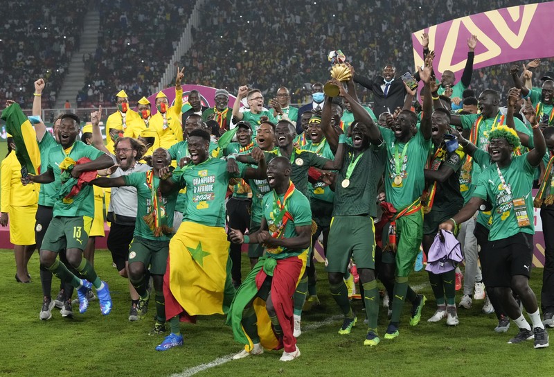 APTOPIX Cameroon African Cup Soccer Senegal's players celebrate with trophy after winning the African Cup of Nations 2022 final soccer match between Senegal and Egypt at the Ahmadou Ahidjo stadium in Yaounde, Cameroon, Sunday, Feb. 6, 2022. (AP Photo/Sunday Alamba)
