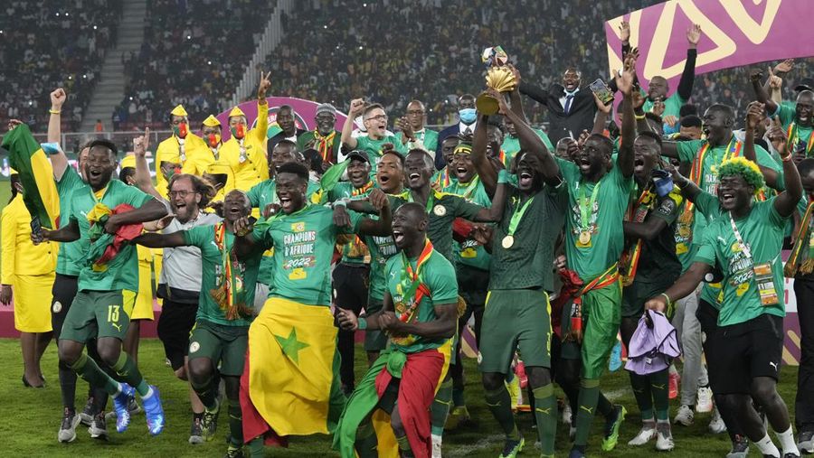 Senegal's players celebrate with trophy after winning the African Cup of Nations 2022 final soccer match between Senegal and Egypt at the Ahmadou Ahidjo stadium in Yaounde, Cameroon, Sunday, Feb. 6, 2022. (AP Photo/Sunday Alamba)