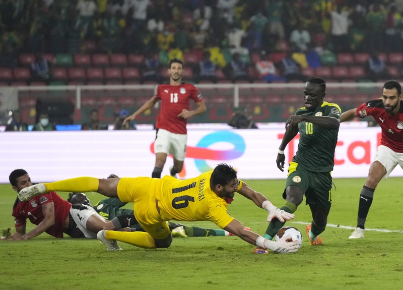 Senegal's players celebrate with trophy after winning the African Cup of Nations 2022 final soccer match between Senegal and Egypt at the Ahmadou Ahidjo stadium in Yaounde, Cameroon, Sunday, Feb. 6, 2022. (AP Photo/Sunday Alamba)