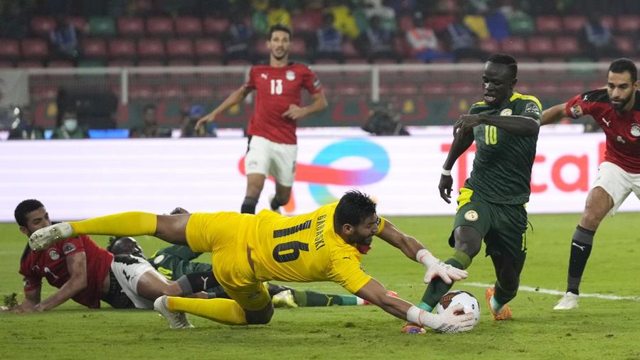 Senegal's players celebrate with trophy after winning the African Cup of Nations 2022 final soccer match between Senegal and Egypt at the Ahmadou Ahidjo stadium in Yaounde, Cameroon, Sunday, Feb. 6, 2022. (AP Photo/Sunday Alamba)
