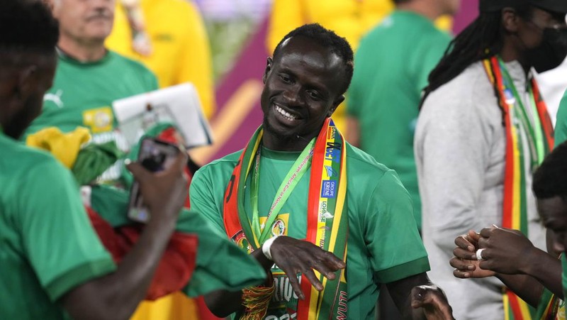 Senegal's players celebrate with trophy after winning the African Cup of Nations 2022 final soccer match between Senegal and Egypt at the Ahmadou Ahidjo stadium in Yaounde, Cameroon, Sunday, Feb. 6, 2022. (AP Photo/Sunday Alamba)