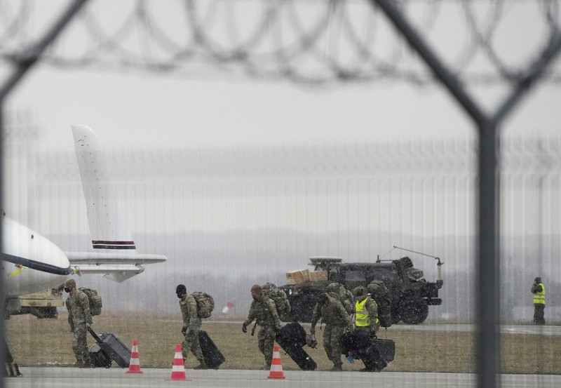 U.S. Army troops of the 82nd Airborne Division unloading vehicles from a transport plane after arriving from Fort Bragg at the Rzeszow-Jasionka airport in southeastern Poland, on Sunday, Feb. 6, 2022. Additional U.S. troops are arriving in Poland after President Joe Biden ordered the deployment of 1,700 soldiers here amid fears of a Russian invasion of Ukraine. Some 4,000 U.S. troops have been stationed in Poland since 2017. (AP Photo/Czarek Sokolowski)