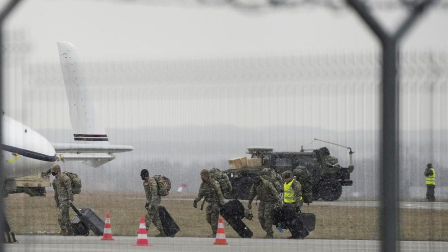 U.S. Army troops of the 82nd Airborne Division unloading vehicles from a transport plane after arriving from Fort Bragg at the Rzeszow-Jasionka airport in southeastern Poland, on Sunday, Feb. 6, 2022. Additional U.S. troops are arriving in Poland after President Joe Biden ordered the deployment of 1,700 soldiers here amid fears of a Russian invasion of Ukraine. Some 4,000 U.S. troops have been stationed in Poland since 2017. (AP Photo/Czarek Sokolowski)