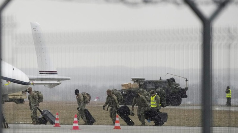 U.S. Army troops of the 82nd Airborne Division unloading vehicles from a transport plane after arriving from Fort Bragg at the Rzeszow-Jasionka airport in southeastern Poland, on Sunday, Feb. 6, 2022. Additional U.S. troops are arriving in Poland after President Joe Biden ordered the deployment of 1,700 soldiers here amid fears of a Russian invasion of Ukraine. Some 4,000 U.S. troops have been stationed in Poland since 2017. (AP Photo/Czarek Sokolowski)