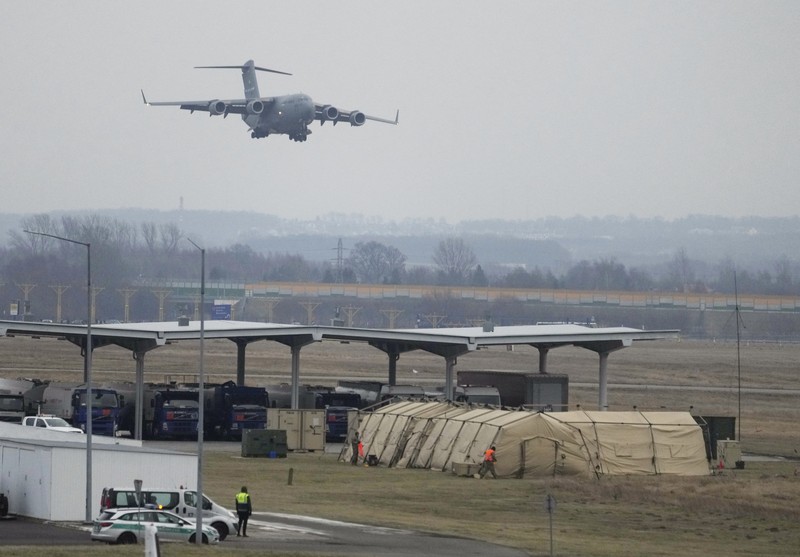 U.S. Army troops of the 82nd Airborne Division unloading vehicles from a transport plane after arriving from Fort Bragg at the Rzeszow-Jasionka airport in southeastern Poland, on Sunday, Feb. 6, 2022. Additional U.S. troops are arriving in Poland after President Joe Biden ordered the deployment of 1,700 soldiers here amid fears of a Russian invasion of Ukraine. Some 4,000 U.S. troops have been stationed in Poland since 2017. (AP Photo/Czarek Sokolowski)