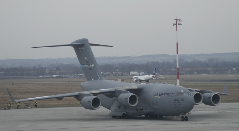 Poland Ukraine Tensions U.S. Army troops of the 82nd Airborne Division unloading vehicles from a transport plane after arriving from Fort Bragg at the Rzeszow-Jasionka airport in southeastern Poland, on Sunday, Feb. 6, 2022. Additional U.S. troops are arriving in Poland after President Joe Biden ordered the deployment of 1,700 soldiers here amid fears of a Russian invasion of Ukraine. Some 4,000 U.S. troops have been stationed in Poland since 2017. (AP Photo/Czarek Sokolowski)