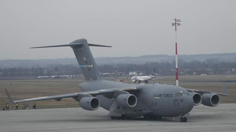 U.S. Army troops of the 82nd Airborne Division unloading vehicles from a transport plane after arriving from Fort Bragg at the Rzeszow-Jasionka airport in southeastern Poland, on Sunday, Feb. 6, 2022. Additional U.S. troops are arriving in Poland after President Joe Biden ordered the deployment of 1,700 soldiers here amid fears of a Russian invasion of Ukraine. Some 4,000 U.S. troops have been stationed in Poland since 2017. (AP Photo/Czarek Sokolowski)