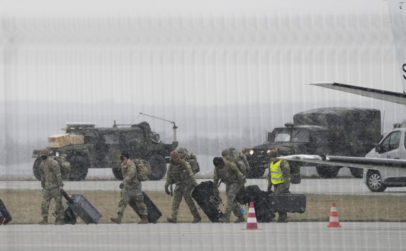 U.S. Army troops of the 82nd Airborne Division unloading vehicles from a transport plane after arriving from Fort Bragg at the Rzeszow-Jasionka airport in southeastern Poland, on Sunday, Feb. 6, 2022. Additional U.S. troops are arriving in Poland after President Joe Biden ordered the deployment of 1,700 soldiers here amid fears of a Russian invasion of Ukraine. Some 4,000 U.S. troops have been stationed in Poland since 2017. (AP Photo/Czarek Sokolowski)