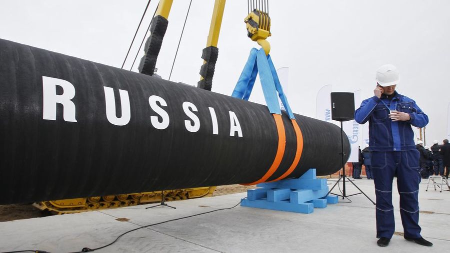 FILE - A Russian construction worker speaks on a mobile phone during a ceremony marking the start of Nord Stream pipeline construction in Portovaya Bay some 170 kms (106 miles) north-west from St. Petersburg, Russia on April 9, 2010. Europe is short of gas. Russia could in theory supply more beyond its long-term agreements, but hasn't, leading to accusations it is holding back to pressure Europe to approve a new controversial Russian pipeline.  (AP Photo/Dmitry Lovetsky, File)