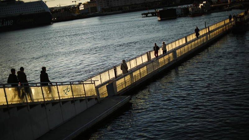 Workers walk over London Bridge towards the City of London financial district during the morning rush hour, in London, Monday, Jan. 24, 2022. The British government have asked people to return to working in offices starting Monday as they ease coronavirus restrictions. (AP Photo/Matt Dunham)