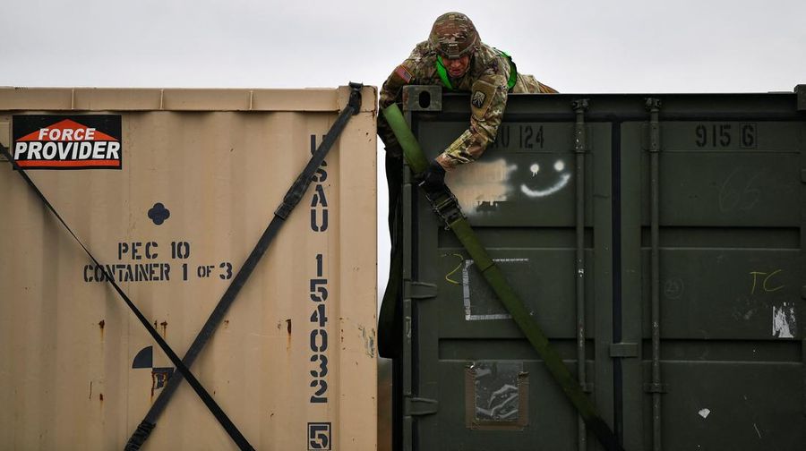 A soldier of the U.S. 2nd Cavalry Regiment stands in a combat vehicle as gear is prepared for deployment to Romania at Rose Barracks in Vilseck, Germany, February 9, 2022.  REUTERS/Lukas Barth