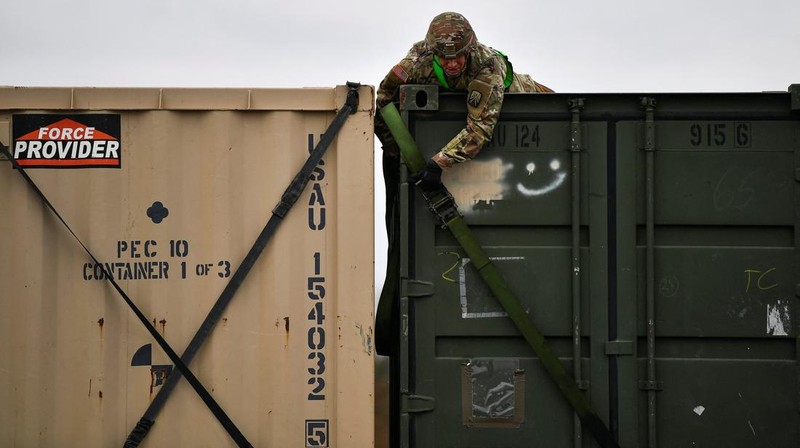 A soldier of the U.S. 2nd Cavalry Regiment stands in a combat vehicle as gear is prepared for deployment to Romania at Rose Barracks in Vilseck, Germany, February 9, 2022.  REUTERS/Lukas Barth