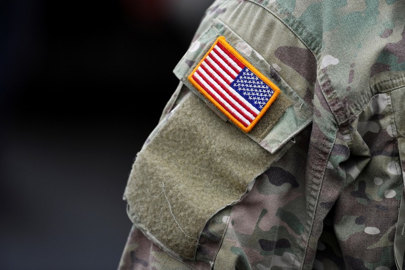 A soldier of the U.S. 2nd Cavalry Regiment stands in a combat vehicle as gear is prepared for deployment to Romania at Rose Barracks in Vilseck, Germany, February 9, 2022.  REUTERS/Lukas Barth