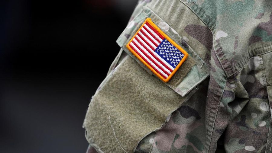 A soldier of the U.S. 2nd Cavalry Regiment stands in a combat vehicle as gear is prepared for deployment to Romania at Rose Barracks in Vilseck, Germany, February 9, 2022.  REUTERS/Lukas Barth