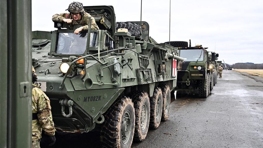A soldier of the U.S. 2nd Cavalry Regiment stands in a combat vehicle as gear is prepared for deployment to Romania at Rose Barracks in Vilseck, Germany, February 9, 2022.  REUTERS/Lukas Barth