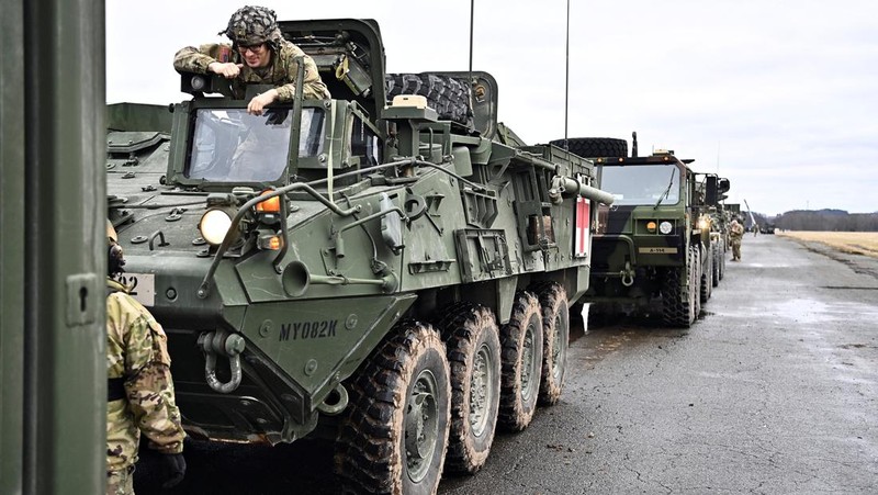 A soldier of the U.S. 2nd Cavalry Regiment stands in a combat vehicle as gear is prepared for deployment to Romania at Rose Barracks in Vilseck, Germany, February 9, 2022.  REUTERS/Lukas Barth