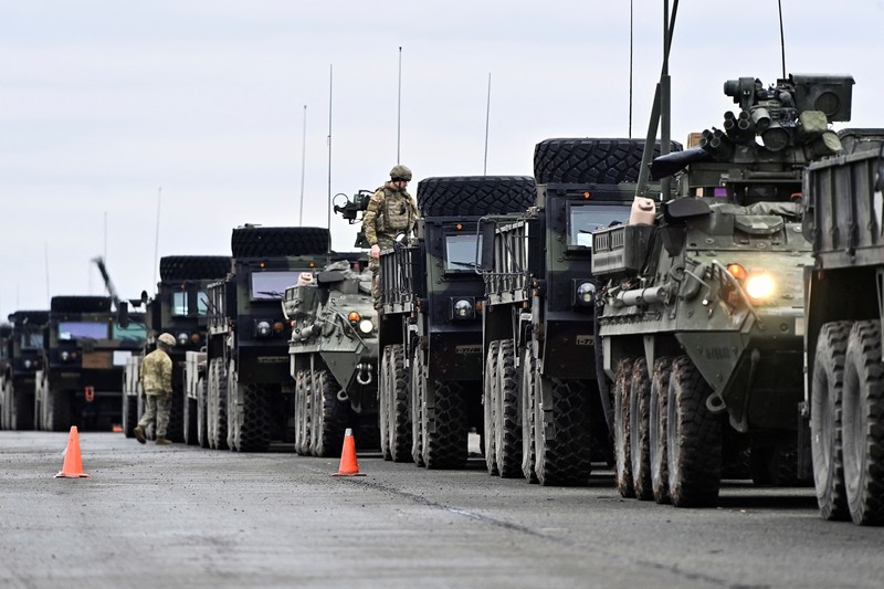 A soldier of the U.S. 2nd Cavalry Regiment stands in a combat vehicle as gear is prepared for deployment to Romania at Rose Barracks in Vilseck, Germany, February 9, 2022.  REUTERS/Lukas Barth