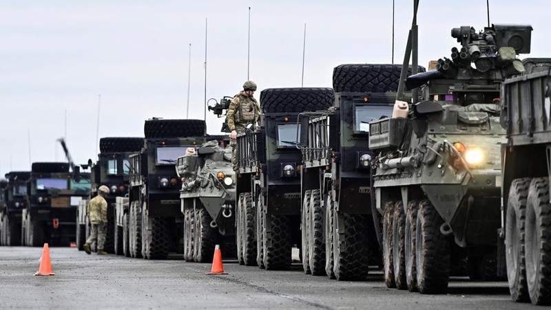 A soldier of the U.S. 2nd Cavalry Regiment stands in a combat vehicle as gear is prepared for deployment to Romania at Rose Barracks in Vilseck, Germany, February 9, 2022.  REUTERS/Lukas Barth