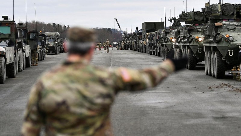 A soldier of the U.S. 2nd Cavalry Regiment stands in a combat vehicle as gear is prepared for deployment to Romania at Rose Barracks in Vilseck, Germany, February 9, 2022.  REUTERS/Lukas Barth