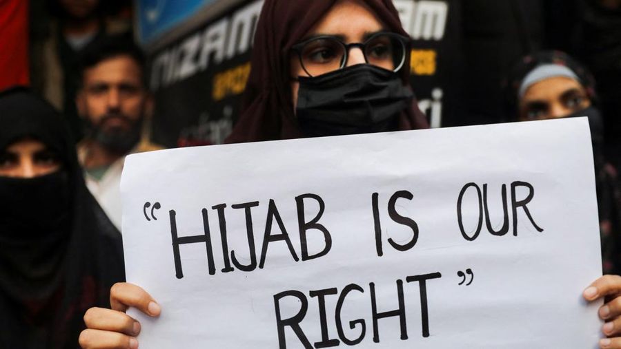 A Muslim woman holds a placard as she takes part in a protest organised by All India Majlis-e-Ittehadul Muslimeen (AIMM) against the recent hijab ban in few colleges of Karnataka state, at Shaheen Bagh in New Delhi, India, February 9, 2022. REUTERS/Anushree Fadnavis