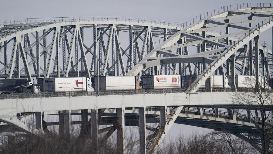 Trucks heading to Canada are stuck in heavy traffic after they were diverted to the Blue Water Bridge in Port Huron, Mich., Wednesday, Feb. 9, 2022, after the Ambassador Bridge was closed due to Canadian anti-vaccine protests. (Mandi Wright/Detroit Free Press via AP)