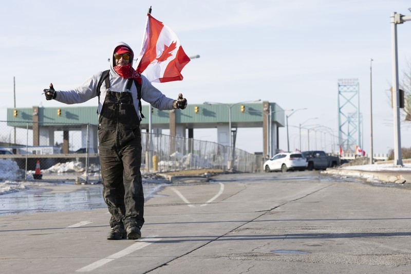 Trucks heading to Canada are stuck in heavy traffic after they were diverted to the Blue Water Bridge in Port Huron, Mich., Wednesday, Feb. 9, 2022, after the Ambassador Bridge was closed due to Canadian anti-vaccine protests. (Mandi Wright/Detroit Free Press via AP)