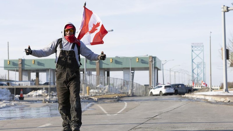 Trucks heading to Canada are stuck in heavy traffic after they were diverted to the Blue Water Bridge in Port Huron, Mich., Wednesday, Feb. 9, 2022, after the Ambassador Bridge was closed due to Canadian anti-vaccine protests. (Mandi Wright/Detroit Free Press via AP)