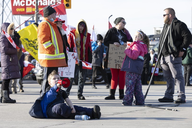 Trucks heading to Canada are stuck in heavy traffic after they were diverted to the Blue Water Bridge in Port Huron, Mich., Wednesday, Feb. 9, 2022, after the Ambassador Bridge was closed due to Canadian anti-vaccine protests. (Mandi Wright/Detroit Free Press via AP)