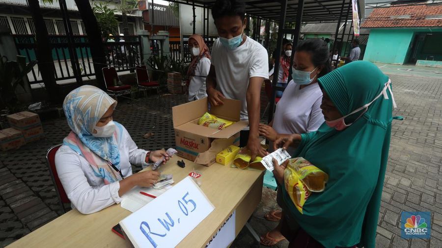 Warga menukarkan kupon untuk membeli minyak goreng saat pasar murah di Kantor Kelurahan Lenkong Karya, Serpong, Tangerang Selatan, Jumat (11/2/2022). (CNBC Indonesia/Andrean Kristianto)