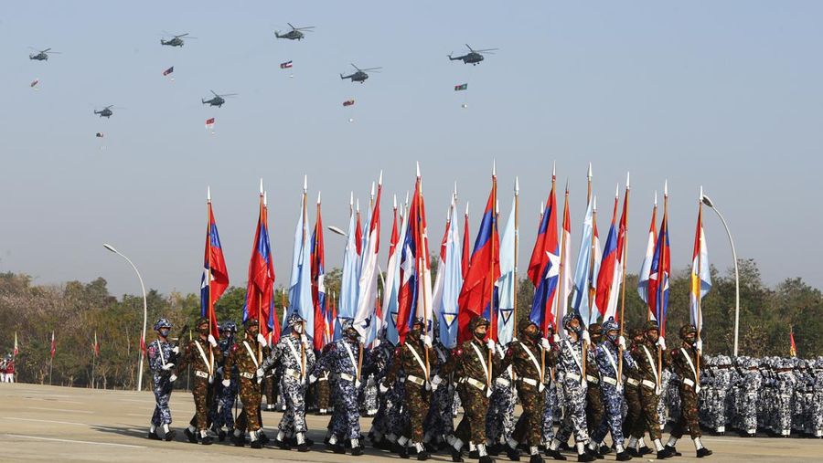 Myanmar military officers march while military fighter planes fly over during a ceremony to mark the 75th anniversary of Union Day Saturday, Feb. 12, 2022, in Naypyitaw, Myanmar. The occasion is celebrated for the date in 1947 when many of the country's ethnic groups signed an agreement to unify following decades of British colonial rule, but it was ineffective, and efforts at unity remain failed. (AP Photo)