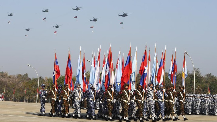 Myanmar military officers march while military fighter planes fly over during a ceremony to mark the 75th anniversary of Union Day Saturday, Feb. 12, 2022, in Naypyitaw, Myanmar. The occasion is celebrated for the date in 1947 when many of the country's ethnic groups signed an agreement to unify following decades of British colonial rule, but it was ineffective, and efforts at unity remain failed. (AP Photo)