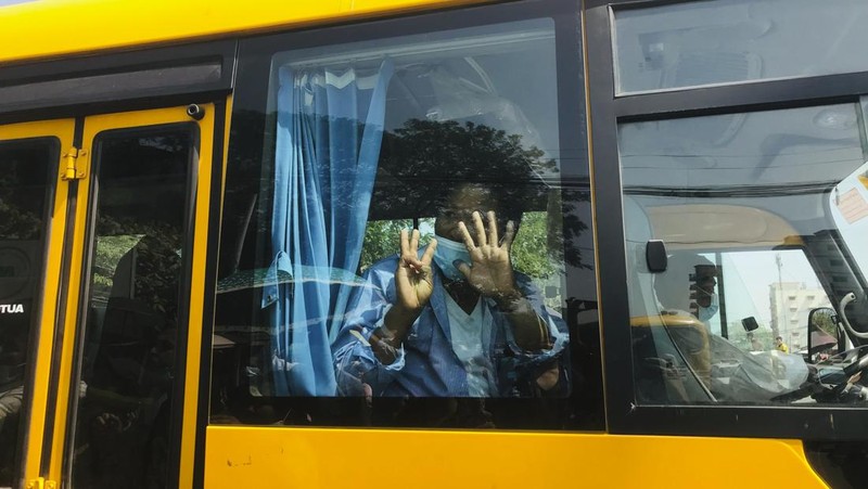 A man gestures with his hands while onboard a bus with prisoners leaving Insein prison during the Union Day holiday in Yangon, Myanmar, Saturday, Feb. 12, 2022. In a customary gesture for national holidays, the head of Myanmar's military government, Senior General Min Aung Hlaing announced an amnesty Saturday covering more than 860 prisoners, state-run newspapers reported. (AP Photo)