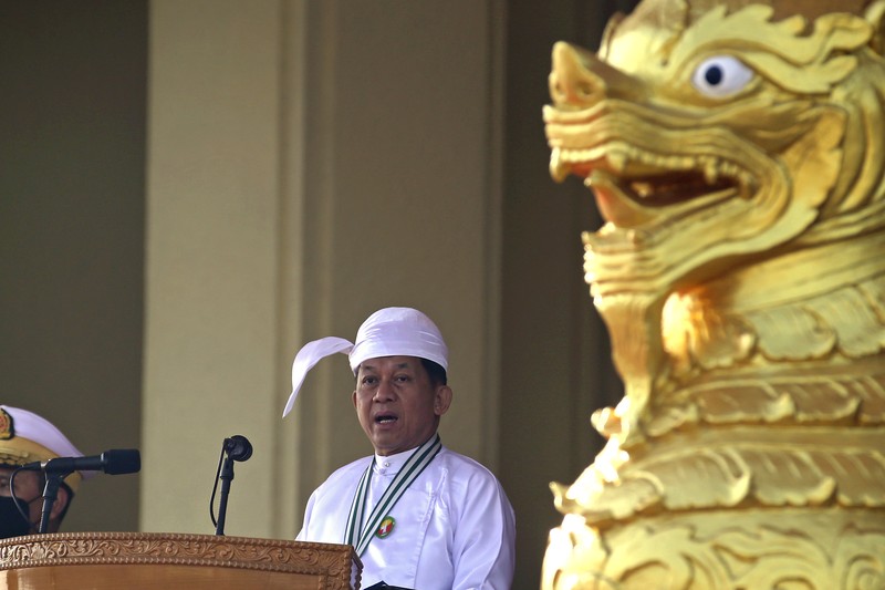 A man gestures with his hands while onboard a bus with prisoners leaving Insein prison during the Union Day holiday in Yangon, Myanmar, Saturday, Feb. 12, 2022. In a customary gesture for national holidays, the head of Myanmar's military government, Senior General Min Aung Hlaing announced an amnesty Saturday covering more than 860 prisoners, state-run newspapers reported. (AP Photo)